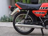a red motorcycle parked on the side of the road