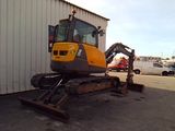 an image of a construction vehicle parked in front of a building