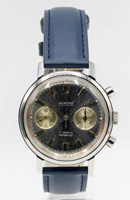 a close up of a watch with a blue strap
