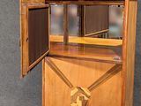 a wooden cabinet with a mirror on top of it