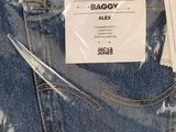 the back pocket of a pair of jeans with a tag on it