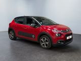 a red citrole is parked in a large room
