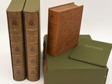 three books are stacked on top of each other on a white surface