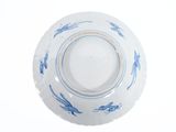 a blue and white bowl with fish on it