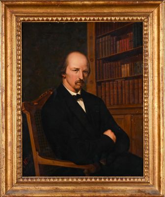 portrait of a man in a black suit and bow tie sitting in a chair