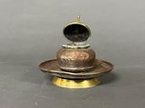 a small metal object on a plate on a table