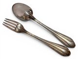 two forks and spoons sitting next to each other on a white surface
