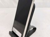 a cell phone that is on a stand on a table