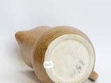 a brown vase sitting on a white surface
