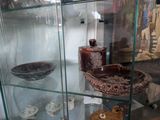 a glass display case filled with different types of vases
