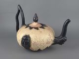 a black and white teapot with a cat on it