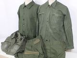two military uniforms that are on display on a table