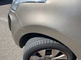 a close up of a car ' s front tire with a sticker on it