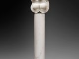 a white marble sculpture of a head on a wooden base
