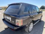 a black land rover parked in a parking lot