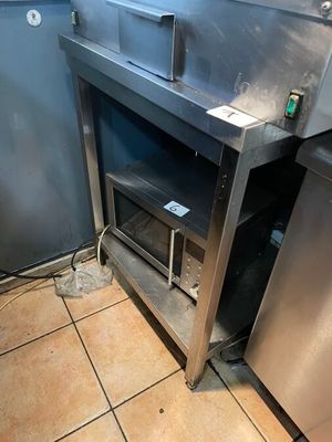 a stainless steel oven in the corner of a kitchen