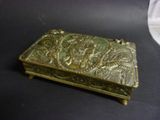 a brass box with a design on it on a table