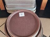 a stack of plates sitting on the floor next to a stack of pans