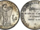 a silver coin with a statue on top of it