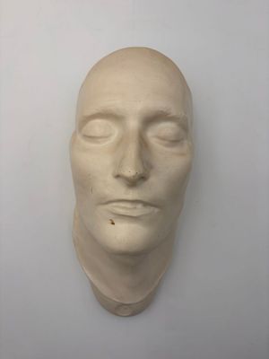 a sculpture of a man ' s face on a wall