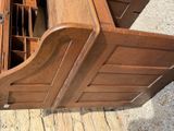 a wooden cabinet that has a drawer inside of it