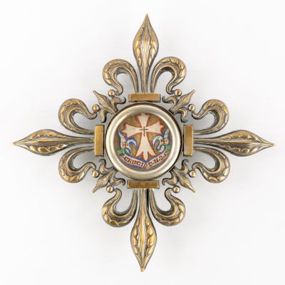 a gold cross with a picture of a person on it