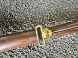 a wooden stick with a metal handle on a carpet