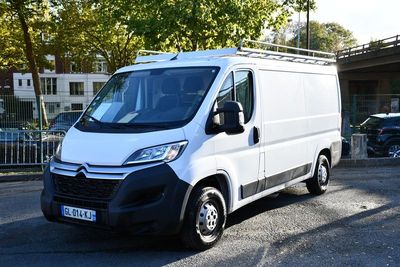 a white van that is parked on the side of the road