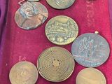a lot of coins that are on display in a case