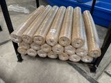 many rolls of fabric on a rack in a warehouse