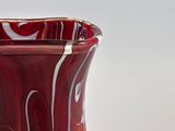 a red vase that is sitting on a table