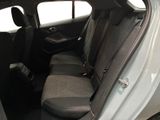 the back seats of a small car with the door open