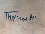 a graffiti on the wall of a building that says thomas a