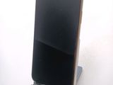 a cell phone that is on a stand on a table