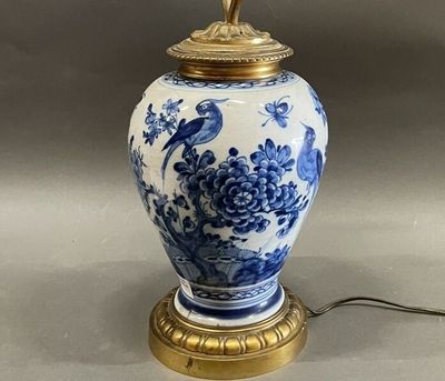 a blue and white vase with a bird on it