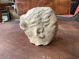 a rock sitting on a table with a chair in the background