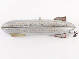 a small metal model of a submarine on a white surface