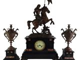 a statue of a man riding a horse on a clock