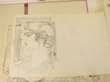 a drawing of a woman on a piece of paper on a table