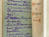 an old book with writing on it sitting on a table
