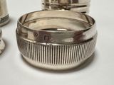 three silver napkin rings sitting on a white table