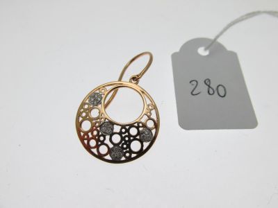a close up of a pair of earrings with a price tag