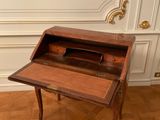a wooden desk with a drawer on it in a room