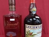 two bottles of alcohol are sitting next to each other on a red background
