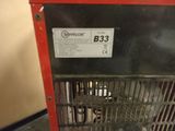 an image of a red and black heater sitting on top of a counter