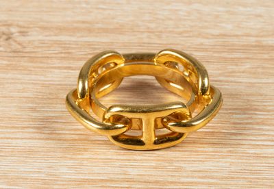 an image of a gold ring on a wooden surface