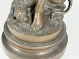 bronze statue of a woman with a dog on a pedestal