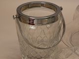 a glass container with a handle and a glass bowl with a lid