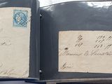 two old envelopes are sitting on top of each other on a table