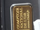 a gold bar in the package on the table